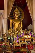 Chiang Mai - The Wat Phra Singh temple. The Viharn Luang (main prayer hall), the Phra Chao Thong Tip, a large statue of seated Buddha.